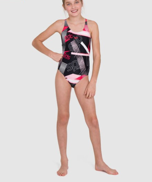 Baddräkt, Speedo Junglespeak Allover TieBack Swimsuit Jr., svart/röd/ljusrosa/vit, en del, för flickor. En ung flicka står barfota med ett självsäkert leende och en hand på höften. Baddräkten har abstrakta mönster i svart, rött, ljusrosa och vitt; den andra armen hänger avslappnat längs sidan.